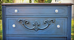 Photo courtesy of Melody Smith of mypassionfordecor.com. Originally gray with outdated flower ceramic hardware, Melody transformed this dresser with navy blue chalk paint and a dark wax top coat accompanied by clear knobs.