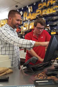 Justin McCarthy, student at the College of Business at The University of Rhode Island, learns from Rob Ferraro, co-owner of Jerry’s Paint and Hardware, during his internship with the store.