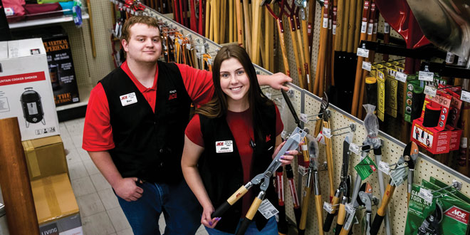 Two young employees in a hardware aisle