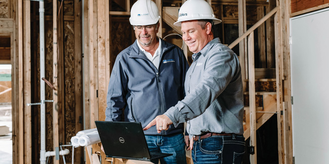 Builders consulting at a jobsite