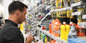 Retail employee scanning an electronic shelf tag